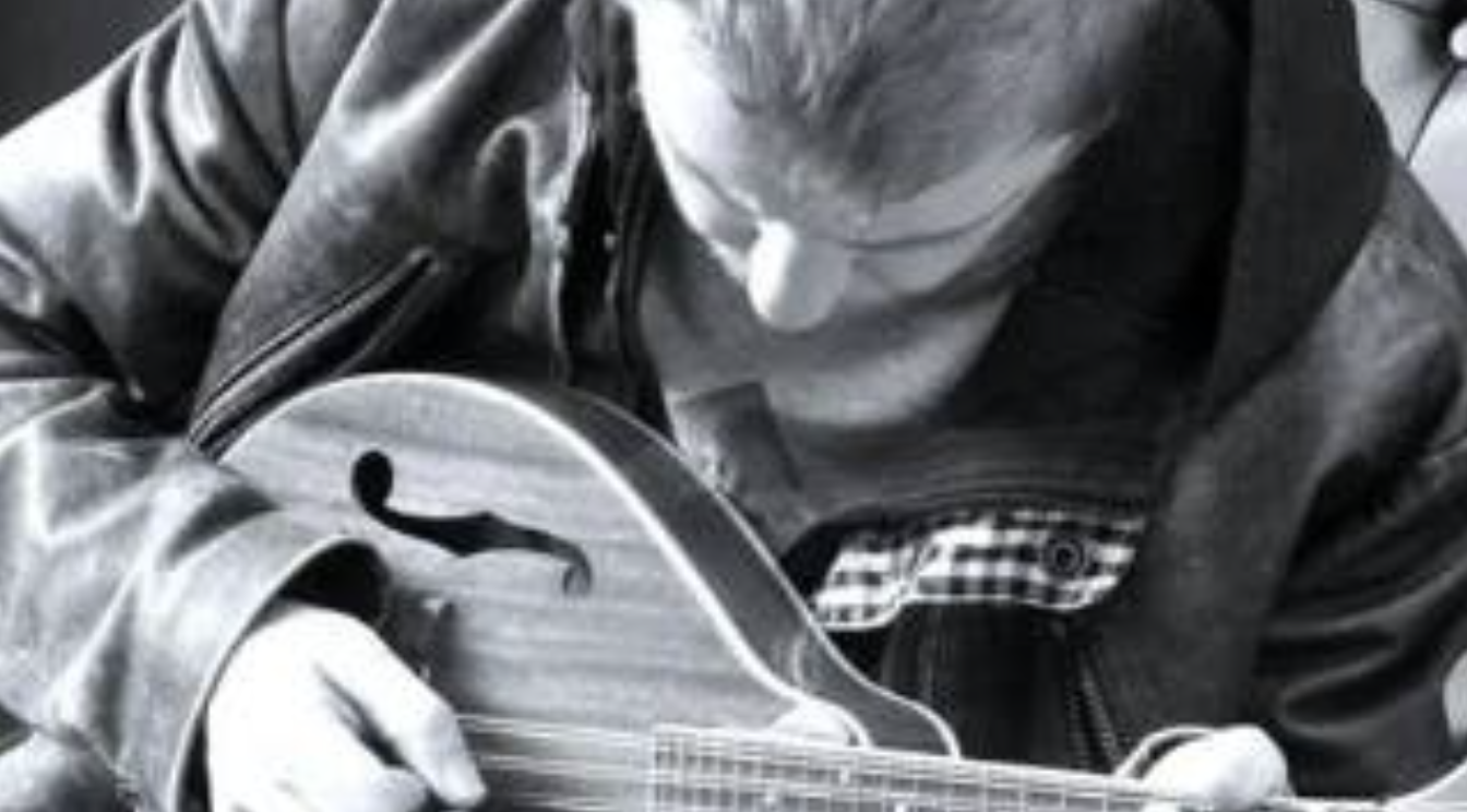 Black-and-white photograph of Ciaran playing banjo